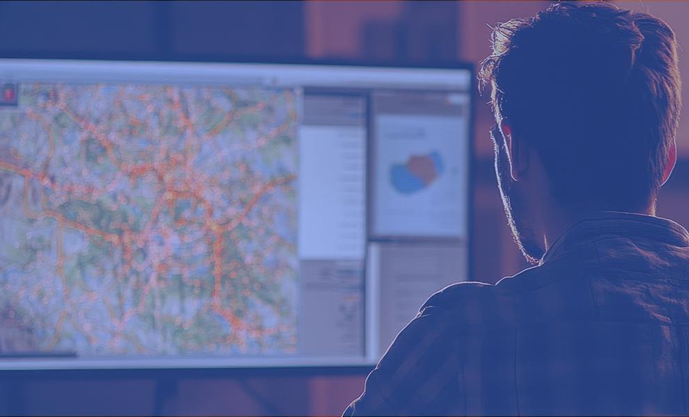 Man looking at a map on a computer screen